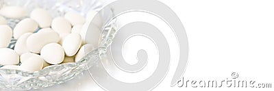 White dragees in a plate for baptism or wedding on panoramic background Stock Photo