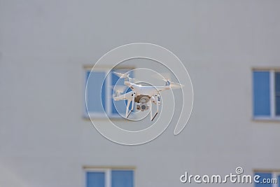 White drone flying above the building Stock Photo