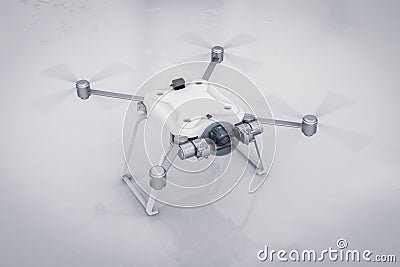 White drone with spinning propellers Stock Photo