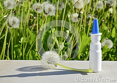 White dropper bottle mock up and dandelions on gray background with shadows with copy space. Concept of allergy treatment. Nose Stock Photo