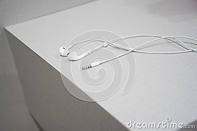 White earphone on the wooden table Stock Photo