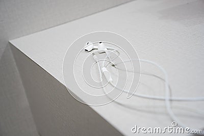 White earphone on the wooden table Stock Photo