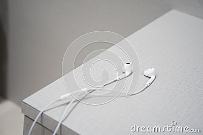 White earphone on the wooden table Stock Photo