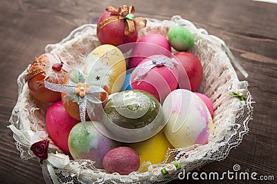 White easter basket with easter eggs on wooden background Stock Photo