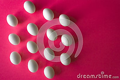 White Easter eggs in hexagon band on bright pink color background with copy space Stock Photo