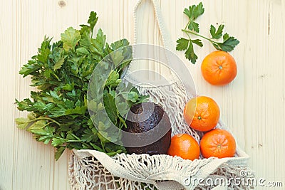 White eco-friendly reusable string bag with fresh fruits, herbs and vegetables Stock Photo