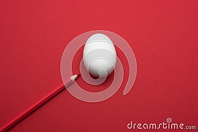 White egg on red background with red pen Stock Photo