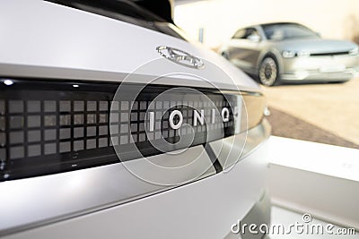 white electric crossover Hyundai IONIQ 5, Logo on cap, trends EV in Europe, technological advancements automotive industry, Editorial Stock Photo