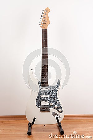 White electric guitar, studio shoot. 2 x Single Coil and 1 x Humbucking. Black Pearl pickguard, Rosewood Fingerboard Stock Photo