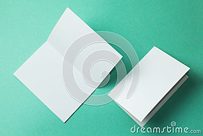 White empty brochure on green background to replace your design. Mockup Stock Photo