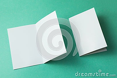 White empty brochure on green background to replace your design. Mockup Stock Photo