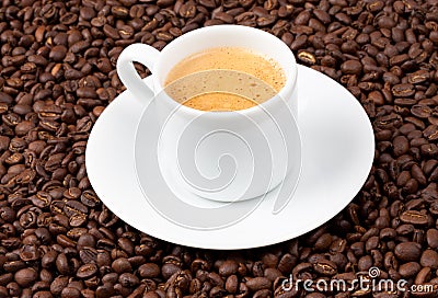 White espresso cup sat on coffee beans Stock Photo