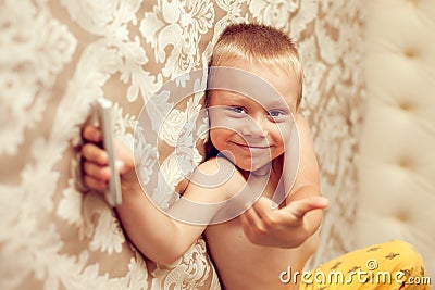 White European 5 years old boy lying on the bed in the bedroom w Stock Photo