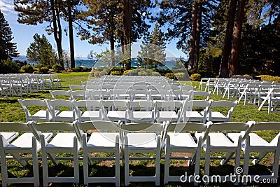 White event chairs in scenic garden by a lake Stock Photo