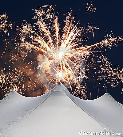 White events tent beneath fireworks Stock Photo