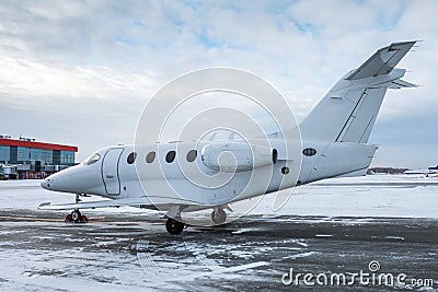 White executive airplane at winter airport apron Stock Photo