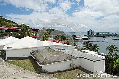 White family house with terrace built in Caribbean style surrounded by palm trees. Stock Photo