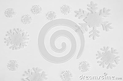 White felt snowflakes on a white background. Stock Photo