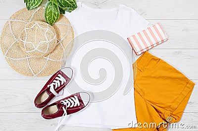 White female t shirt mock up flat lay on wooden background. Top view and copy space. Mockup t-shirt and summertime. Template blank Stock Photo