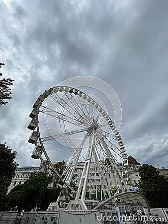 White ferris wheel against the background of a building in Elizabeth Square. Budapest, Hungary Editorial Stock Photo