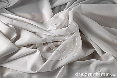 White fine chiffon fabric with a woven texture. Gathered in a spiral and crushed textiles. Silky light Stock Photo