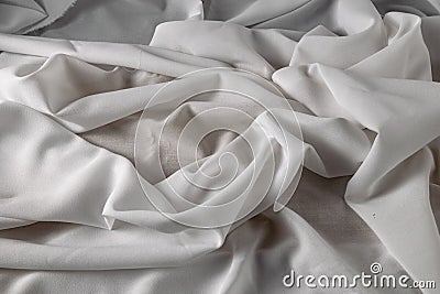 White fine chiffon fabric with a woven texture. Gathered in a spiral and crushed textiles. Silky light Stock Photo
