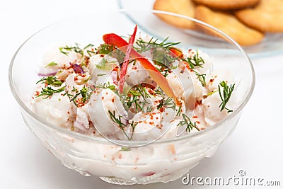 White fish Peruvian ceviche served in a transparent bowl with crackers Stock Photo