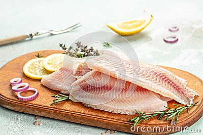 White fish tilapia fillet ready to cook. superfood concept. Healthy, clean eating Stock Photo