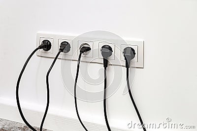 White five-way wall power socket on white wall Stock Photo