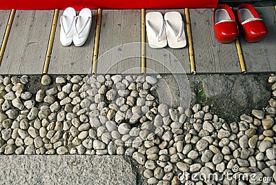 White flip-flops and red clogs Stock Photo