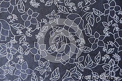 White floral print on dark blue fabric from above Stock Photo