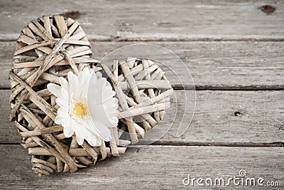 White flower and wicker decorative heart Stock Photo