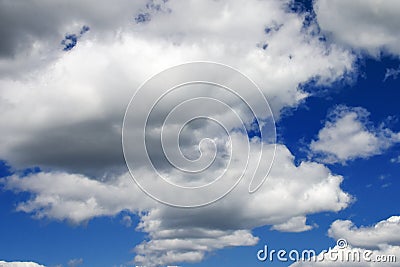 White fluffy clouds in a dark blue sky Stock Photo