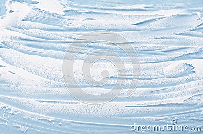 White foam texture close up on blue background. Soapy substance with bubbles backdrop. Creamy grainy macro. Shower gel, washing Stock Photo