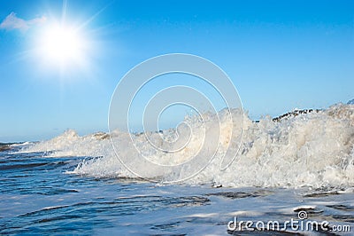 White foam on wave crest. Evening beach. Stock Photo