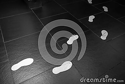 White footprints on a black floor Stock Photo