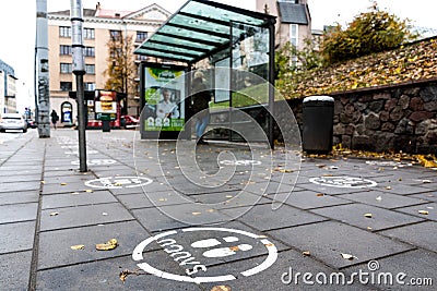 White footprints marked sign on the footpath at the bus stop Editorial Stock Photo