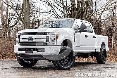 White 2020 Ford F-250 pickup truck with lifted wheels on a dirt road Editorial Stock Photo