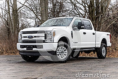 White 2020 Ford F-250 pickup truck with lifted wheels on a dirt road Editorial Stock Photo