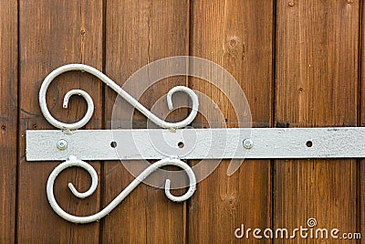 White forged hinge put on wooden door close-up Stock Photo