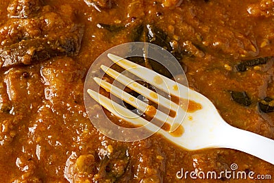 White fork in an eggplant curry meal Stock Photo