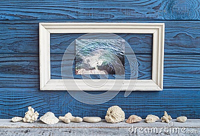 White frame whith foto and shells on a background of blue boards Stock Photo