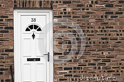 White front door of a red brick English town house. Manchester. Stock Photo