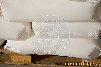 White full bags on a pallet in dry warehouses. Stock Photo