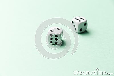 White gaming dice on mint background. Top view. Flat lay. Copy space Stock Photo