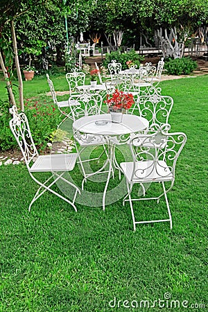 White garden furniture in beautiful garden. Stock Photo