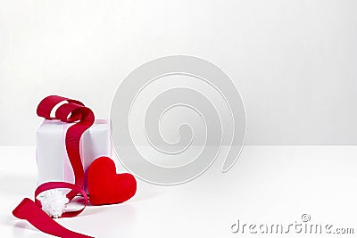 White gift box and red heart shaped fabric and white pom pom with red ribbon Stock Photo