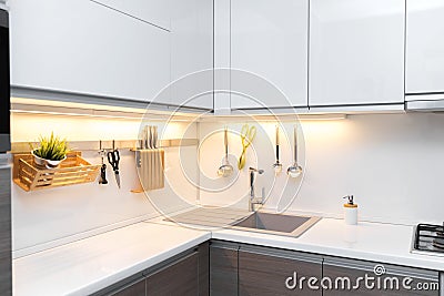 White gloss kitchen interior with worktop lighting Stock Photo