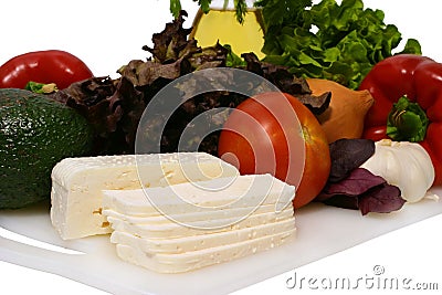 White goat feta cheese and vegetables on plate Stock Photo