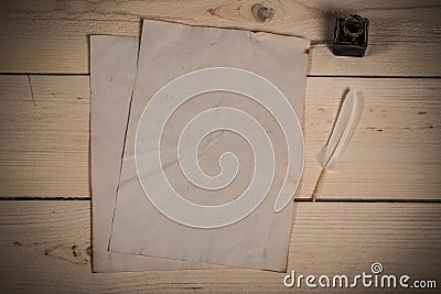 Feather and old paper sheets Stock Photo
